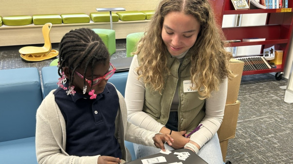 Ohio State student teacher reading with a young student