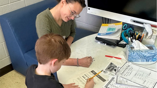 Ohio State teacher helping student with class work