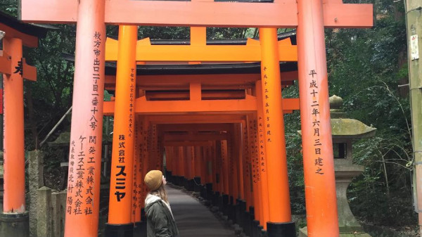 student standing be tori gate in Japan