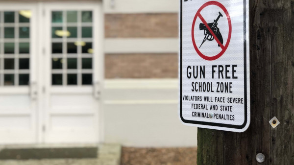 Gun Free zone sign in front of school building