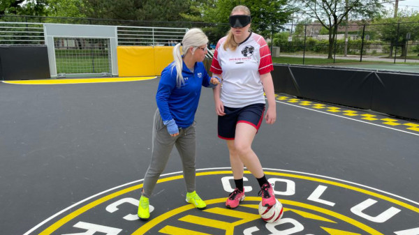 Ohio State Katie Smith coaching blind soccer player on Columbus Crew field
