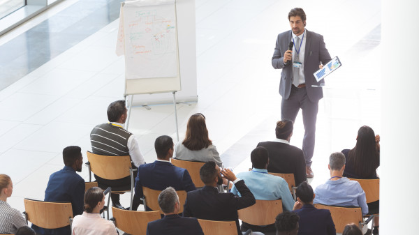 businessman-giving-speech-at-business-conference