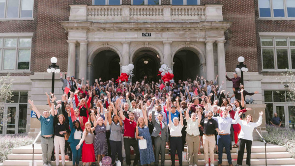 EHE facutly and staff celebrate the opening of the renovated Campbell Hall on the front steps