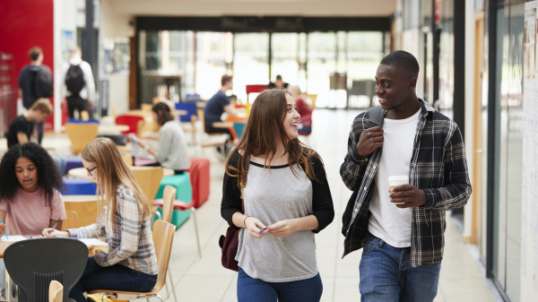 communal area of busy college campus with students