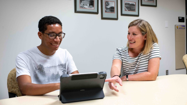 School counselor with Ohio State student meeting at a desk