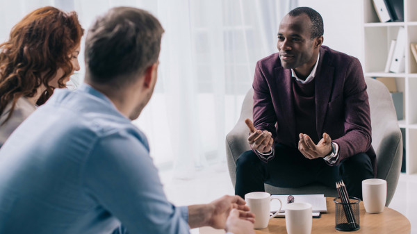 counselor speaking to man and woman