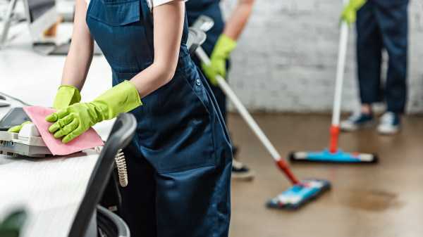 cropped-view-women-cleaning-phone-with-colleagues