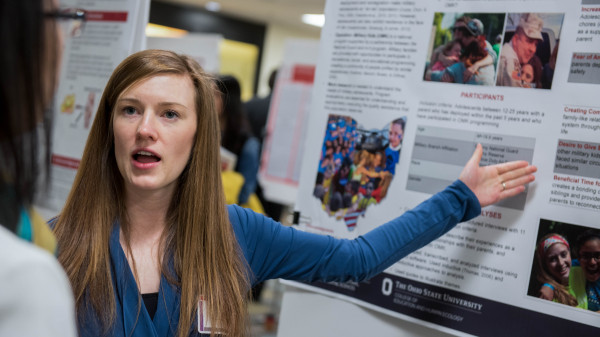 student with research poster