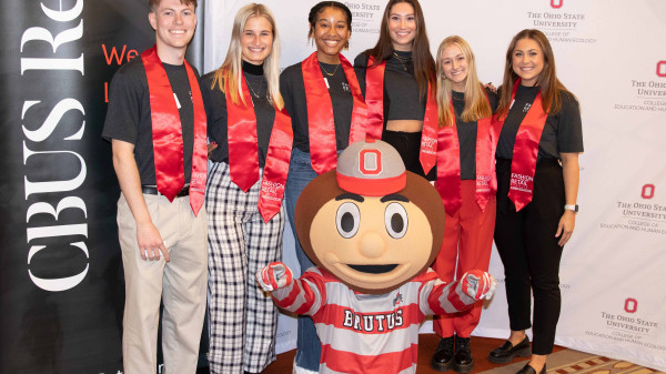 Ohio State fashion and retail studies students posing with Brutus the Buckeye