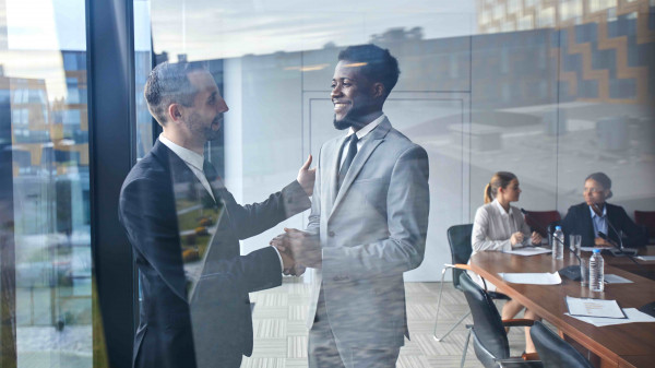 business men shaking hands in conference room