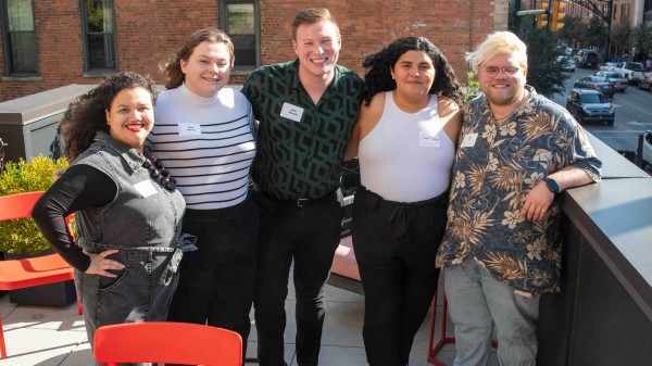 Students at a HESA alumni event on a rooftop