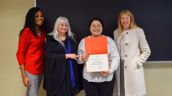 Ju-A Hwang standing with a group of women with her award