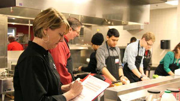 students preparing food in kitchen