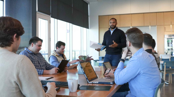 Ohio State students in a meeting room listening to a presentation about financial services