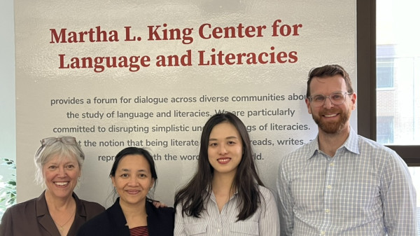 Martha L. King Center members standing in front of a sign for the center