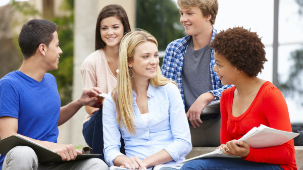 multi-racial student group sitting outdoors