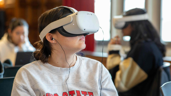 Student in an Ohio State sweatshirt using a virtual reality headset.