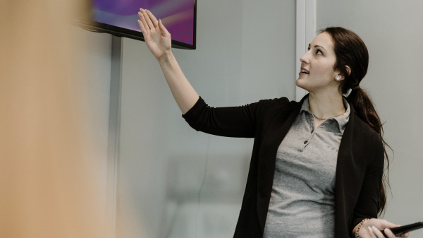 professor pointing to tv