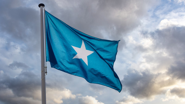 somalia flag waving against cloudy sky