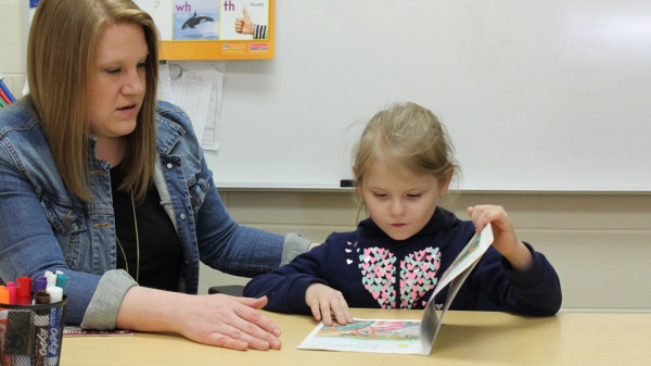 Teacher and student reading book