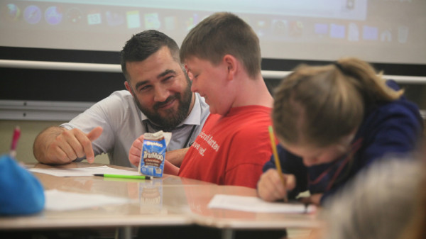 teacher helping young students