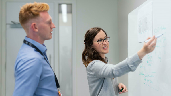 Graduate students at board