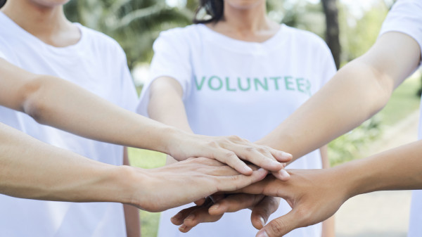 volunteers standing hands