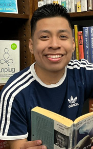 Headshot of Ohio State's Eddie Bautista-Garcia reading in a library