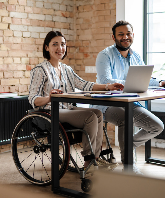 person in wheelchair working at desk