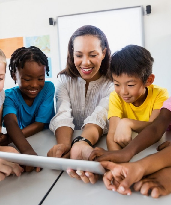 teacher and students looking at tablet