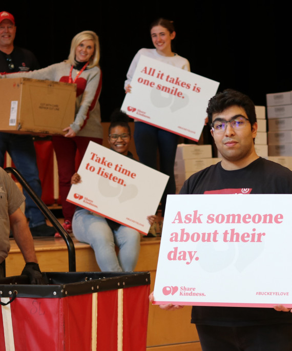 Ohio State students holding signs with words of kindness