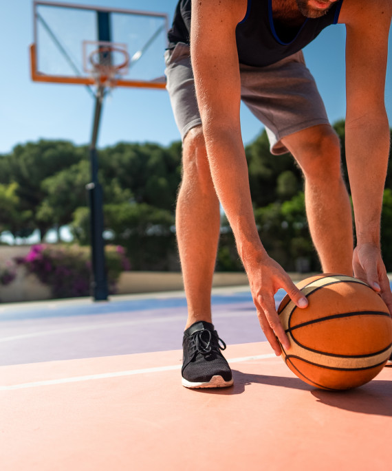 basketball-player-on-the-playground-picks-up-the-ball