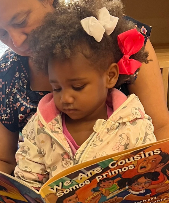 Teacher reading picture book to child