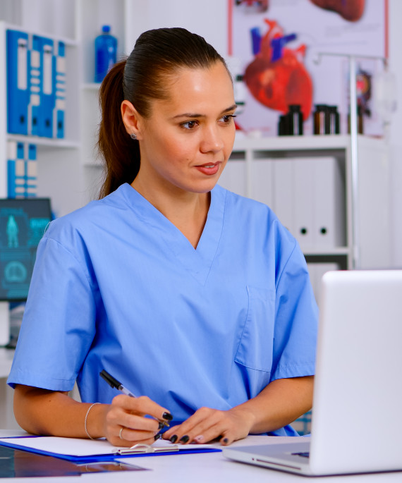 doctor assistant in uniform working on laptop