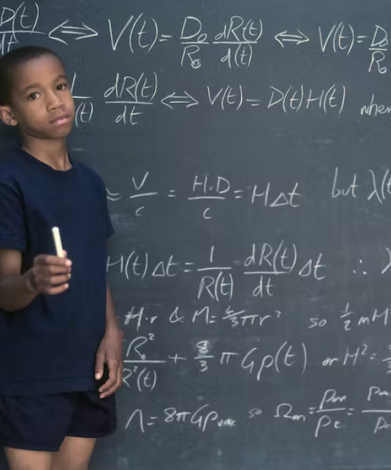 Young student in front of chalkboard with equations