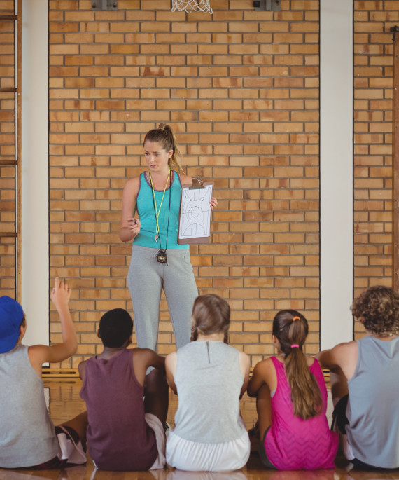 female-coach-mentoring-high-school-kids