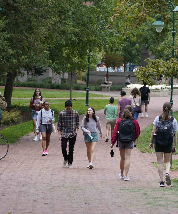 Ohio State students walking and riding bikes in the Oval