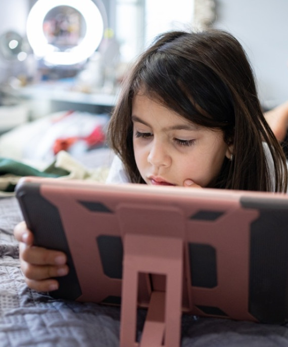 Young girl using iPad tablet