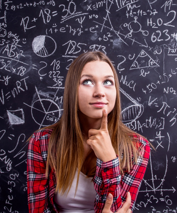 student in front of blackboard