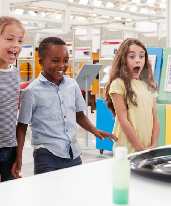 kids having fun watching science experiment