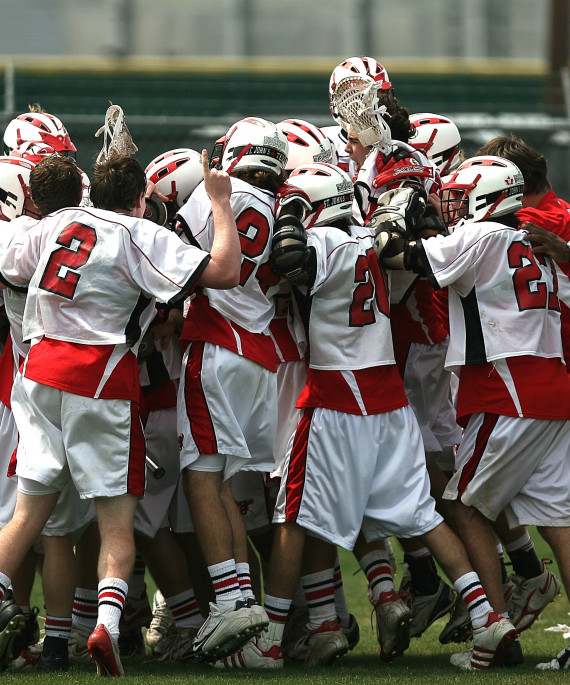 lacrosse team celebrating on field