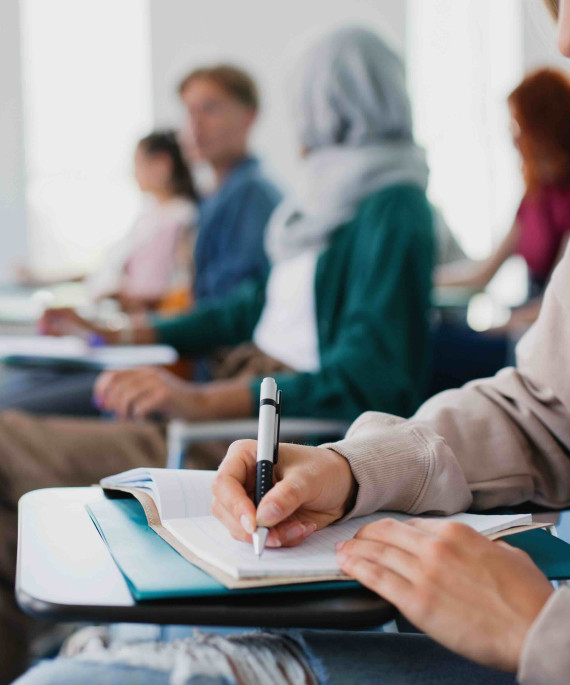 college students taking notes in class