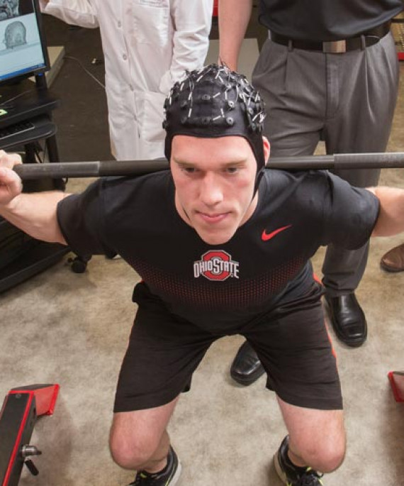 a man in a black shirt lifting a barbell