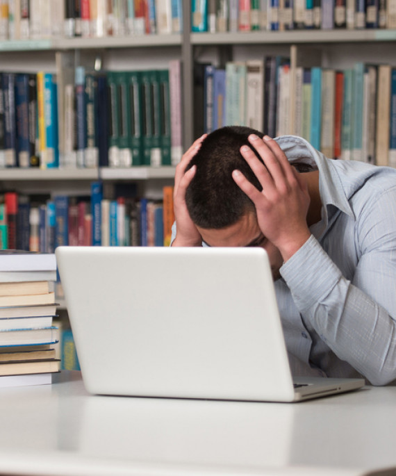 student with hands on head