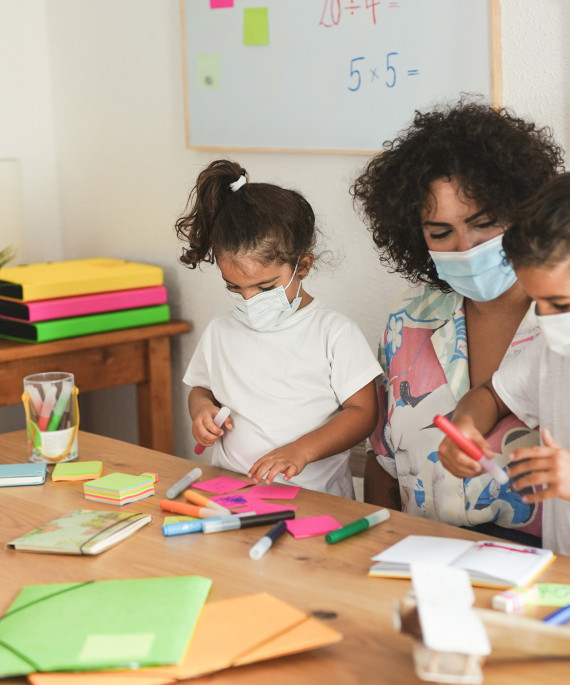 teacher helping young students