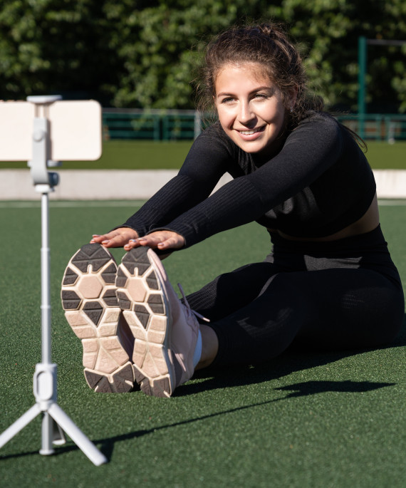 woman vlogger demonstrating exercises for online