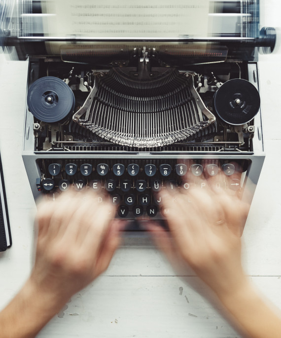 writer typing with retro writing machine