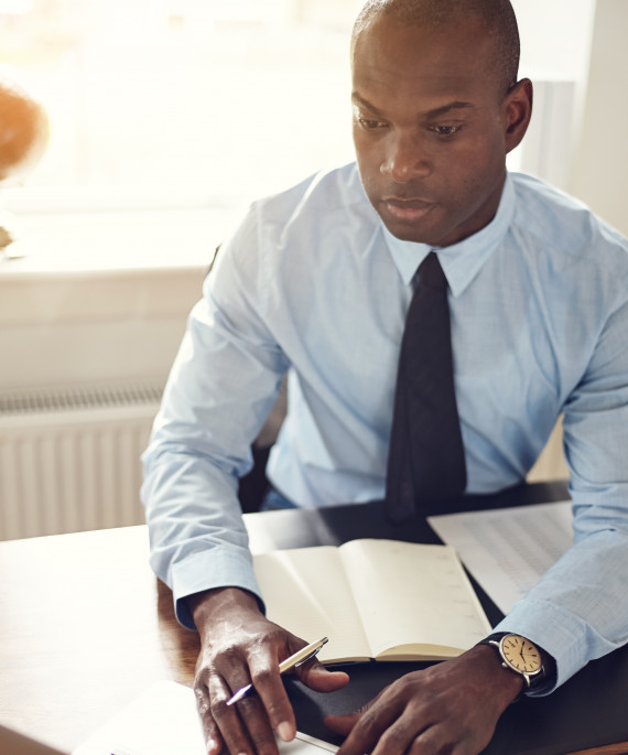 young-executive-working-on-a-laptop-in-an-office