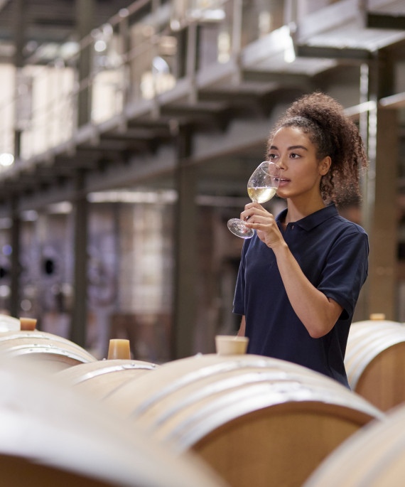young-woman-wine-tasting-in-a-wine-factory-warehou