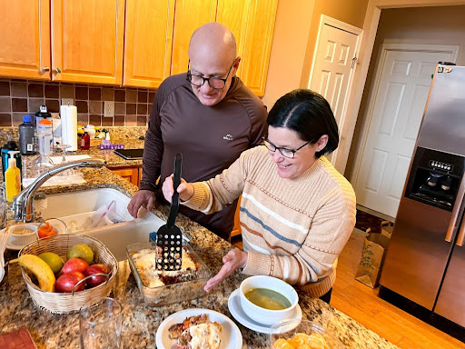 Angel Kowalski and his wife cook dinner in their kitchen.